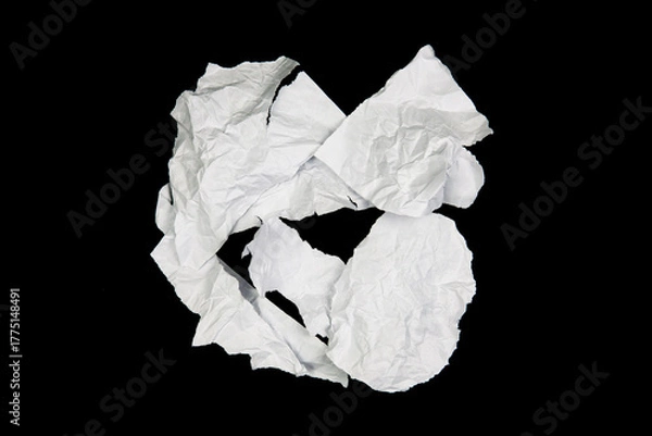 Fototapeta White paper cut with torn edges isolated on black background.