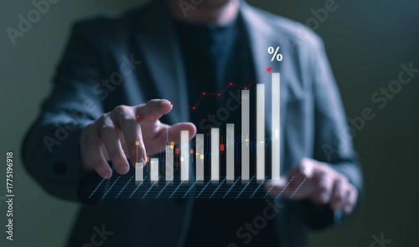 Fototapeta A modern business concept image illustrating economic growth, inflation, and financial data analysis. The photo shows a close-up of a person typing on a laptop keyboard with a holographic bar chart