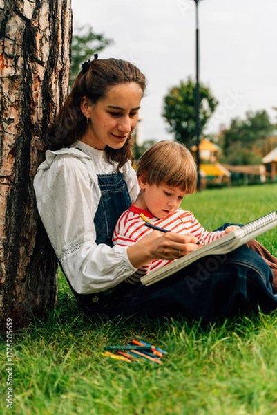 Fototapeta Mother and Toddler Drawing Together in a Summer Park. Parenting and Childhood Development Concept