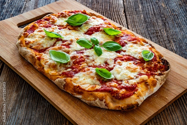 Obraz Pinsa Margherita with tomato sauce, basil leaves and mozzarella cheese on wooden background