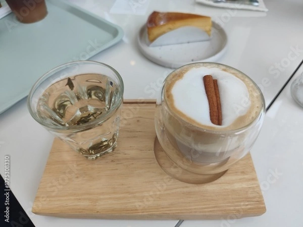 Fototapeta Glass of water and ้hot coffee on top cinnamon stick