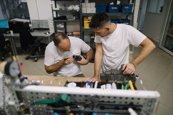 Obraz Two orthopedic specialists assembling artificial limb together