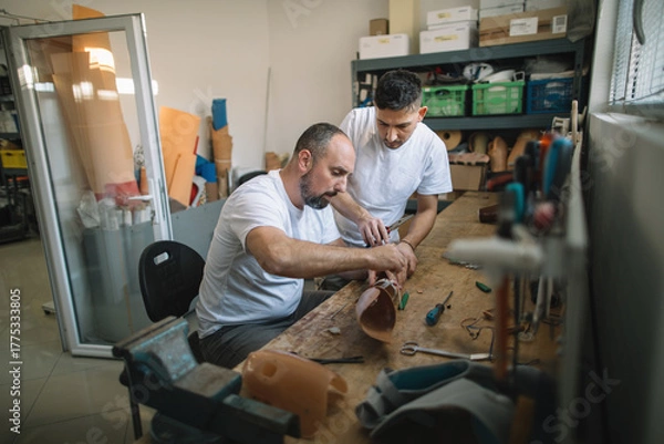 Obraz Orthopedic specialists assembling artificial limb together