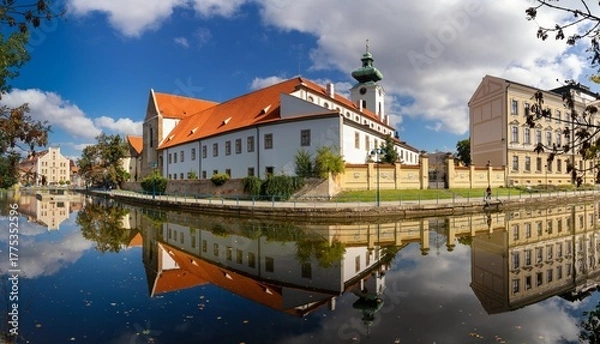 Fototapeta view of the historic Dominican monastery on the Malse River in downtown Ceske Budejovice with reflections and autumn colours