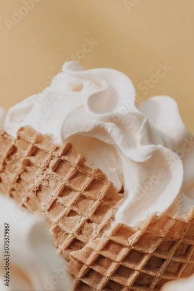 Fototapeta Horizontal view of a light waffle cone lying on its side with vanilla ice cream