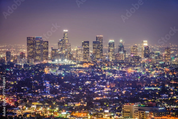Fototapeta Close panoramic night view of Los Angeles city skyline from Griffith Observatory, vibrant urban lights, modern architecture, glowing downtown buildings, twilight sky, travel destination, California US