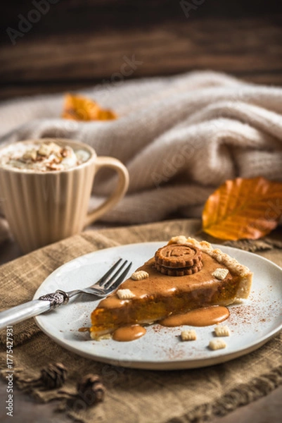 Fototapeta Piece of pumpkin pie with caramel sauce and cookie on a wooden table