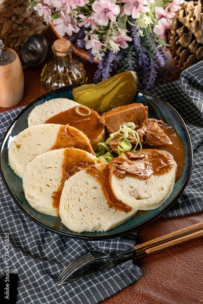 Fototapeta Czech dumplings with stewed pork in sauce.