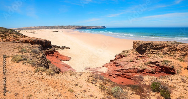Fototapeta lonely Bordeira sand beach with red sandstone, West Algarve coast Portugal