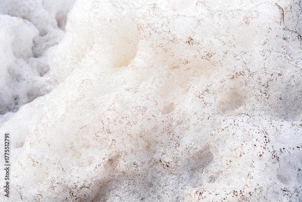 Fototapeta Detail background of Murky foam piles created by floating fast from flow of polluted water from a large water pump for wastewater treatment.