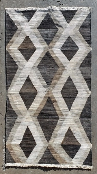 Fototapeta Textured diamond pattern rug with abstract black white and brown coloration for home decor