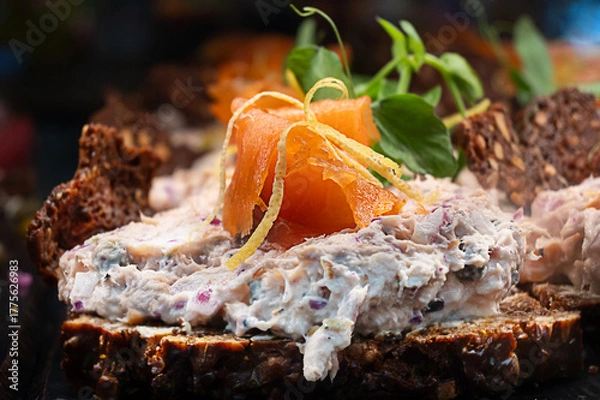 Obraz Traditional Danish smorrebrod, open-faced sandwich with salmon on dark rye bread.