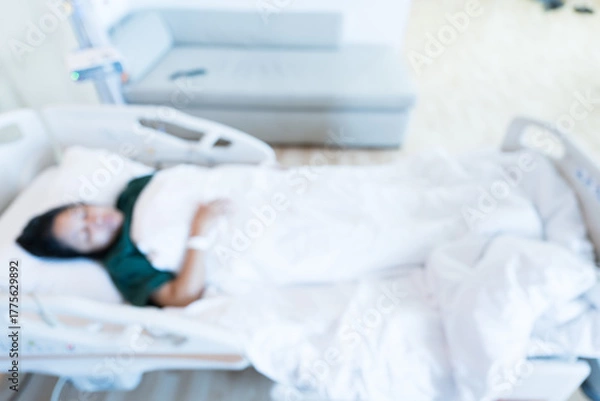 Obraz Blur image of patient on bed and nurse working area in internal medicine departments at the hospital.Medical treatment emergency patient.Caregiver and hopeful concept.