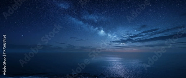 Fototapeta Vast dark blue ocean under a starry night sky with the Milky Way and moonlit water reflections stars