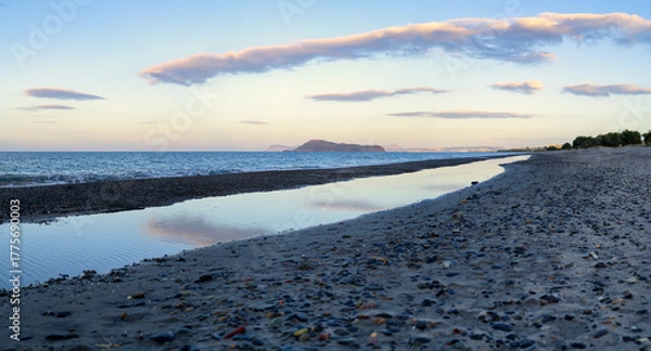 Fototapeta Tranquil Pebble Beach with Reflections at Sunset in Crete