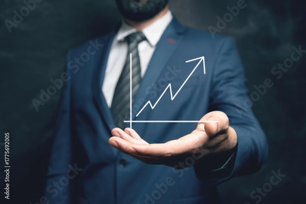 Obraz hand holding a chart with an arrow pointing up