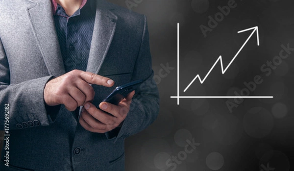 Obraz hand holding a chart with an arrow pointing up