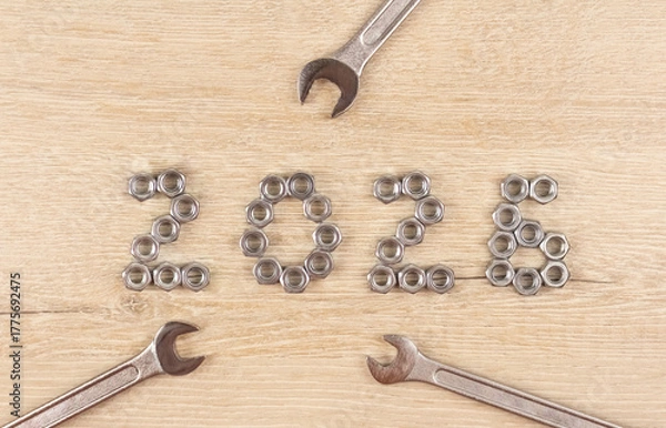 Obraz Light wood background with number 2026 by metal nuts with wrenches. 2026 year