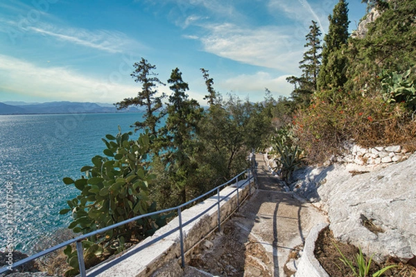 Obraz Scenic coastal path with sea view and lush vegetation in Nafplio, Peloponnese, Greece