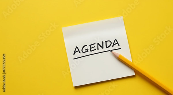 Fototapeta Agenda written on a sticky note with a pencil on yellow background