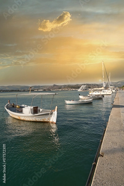 Obraz Traditional fishing boats and yachts docked at a peaceful harbor during golden sunset
