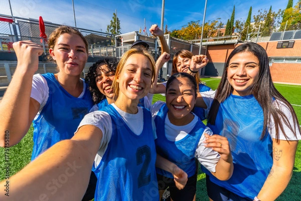 Obraz Happy women soccer team celebrating victory taking selfie