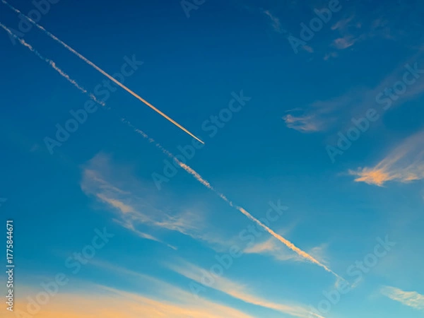 Obraz Aeroplane Trails Over a Blue Sky