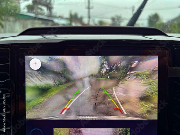 Obraz Rain drops on car rearview camera lens causing blurred vision and safety issue