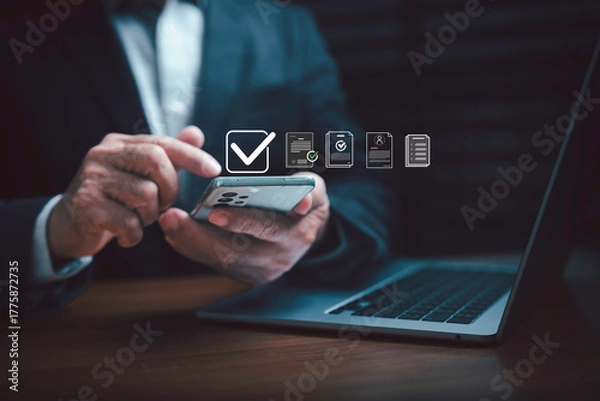 Fototapeta Businessman using smartphone for digital document management and online approval process. Concept of mobile technology, data security, e-signature, and remote business communication.
