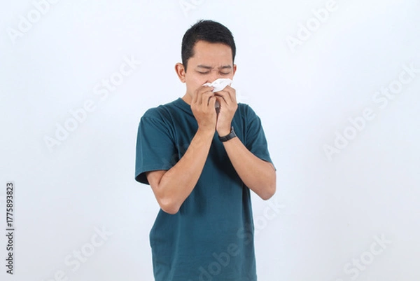 Obraz Sick man blowing nose with tissue. Cold, flu or allergy symptom.