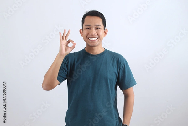 Obraz Smiling Asian Man Showing OK Sign. Happy Man Giving Approval Gesture.