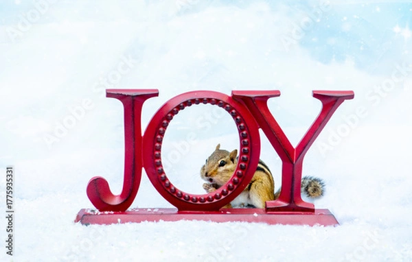 Obraz chipmunk hides behind a JOY sign in the snow, in this adorable holiday scene with text space