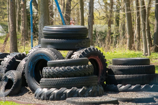 Fototapeta Tire tower on a play ground, built for children to climb on and play, but also recycle old tires 