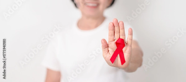 Obraz Elderly with Red Ribbon for December World Aids Day, MADD, October Red ribbon week, February Heart month, Marfan Syndrome, May Stroke awareness, March world TB Tuberculosis day and April Dare day