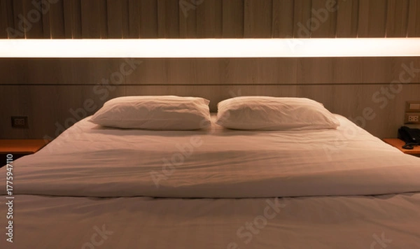 Obraz bed under warm light in hotel