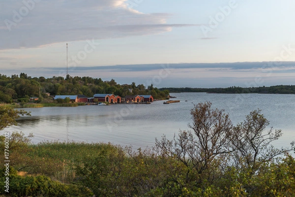 Fototapeta Distant red boathouses in Finland archipelago Brändö island.