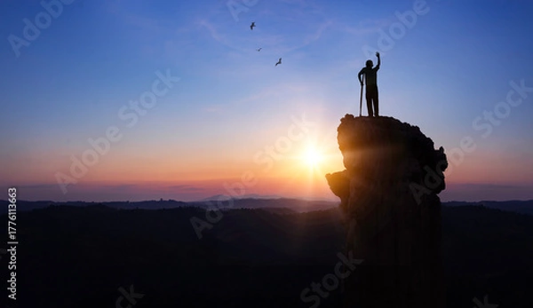 Fototapeta Silhouette a disabled man standing up and raising his hand at  sunrise background