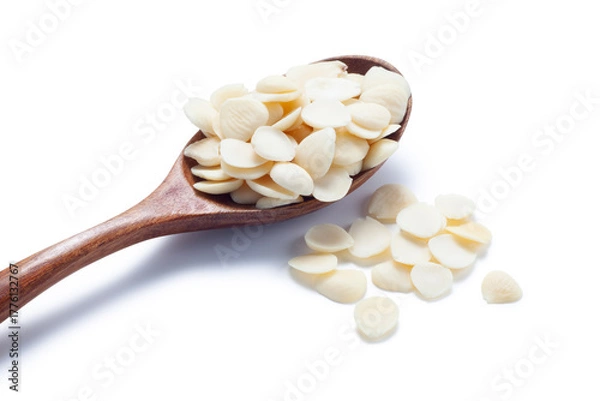 Fototapeta sliced ​​almonds in a wooden spoon isolated on white background