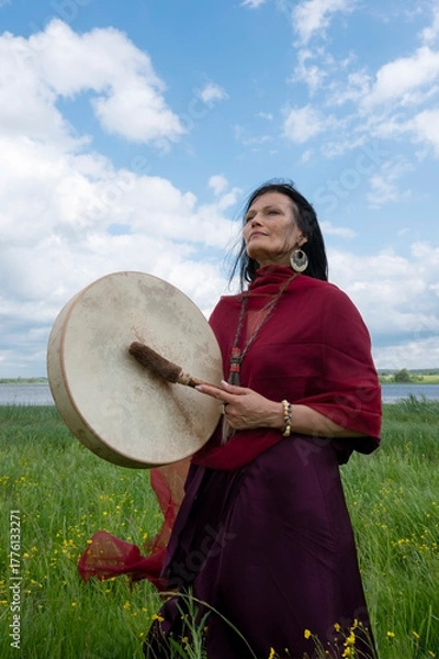 Fototapeta Portrait of a middle-aged shaman woman with a red headscarf