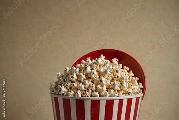 Obraz Full striped popcorn bucket with lid on brown background