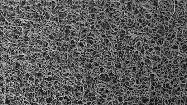 Fototapeta Background of wire doormat. close up of rough mat surface. Seamless abstract doodle texture. doormat made of synthetic material.