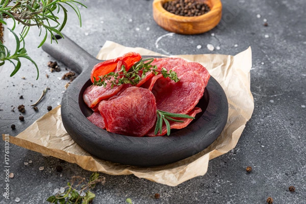 Fototapeta Cold smoked meat, pork chops on gray background