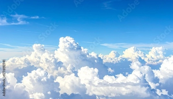 Obraz Fluffy white clouds against a blue sky, aerial view. Pure and bright, capturing atmosphere and depth