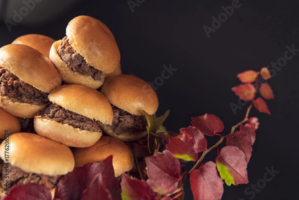 Fototapeta Mini beef sliders stacked on a glass stand with autumn leaves