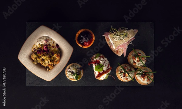 Fototapeta Minimalist presentation of assorted gourmet appetizers