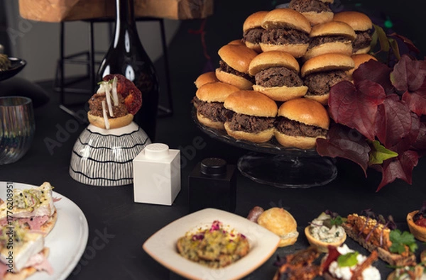 Fototapeta Assorted gourmet canapés on white plate with creative toppings