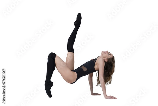 Obraz ballerina with beautiful feet poses in a photo studio, a ballerina dressed in total black poses sitting on the floor