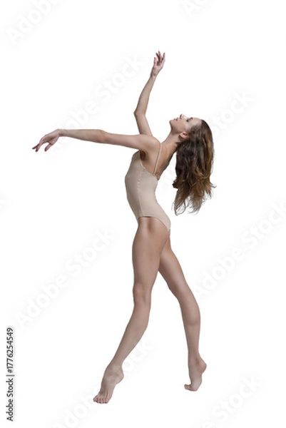 Fototapeta ballerina with beautiful feet poses in a photo studio, a ballerina in a leopard walks with her arms up