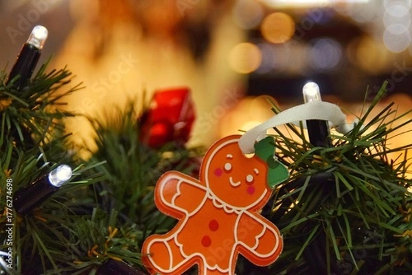 Fototapeta Gingerbread man on a spruce branch.