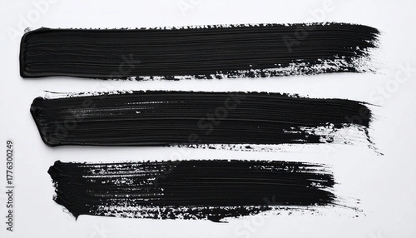 Fototapeta Three horizontal black brush strokes with varied texture on white background